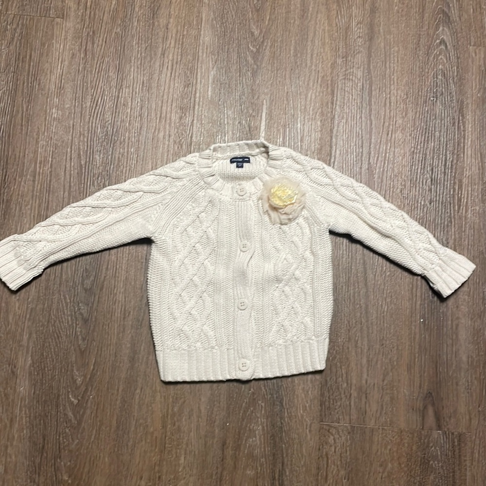 Baby gap button up knit sweater. Cream color with flower on one side. Like new